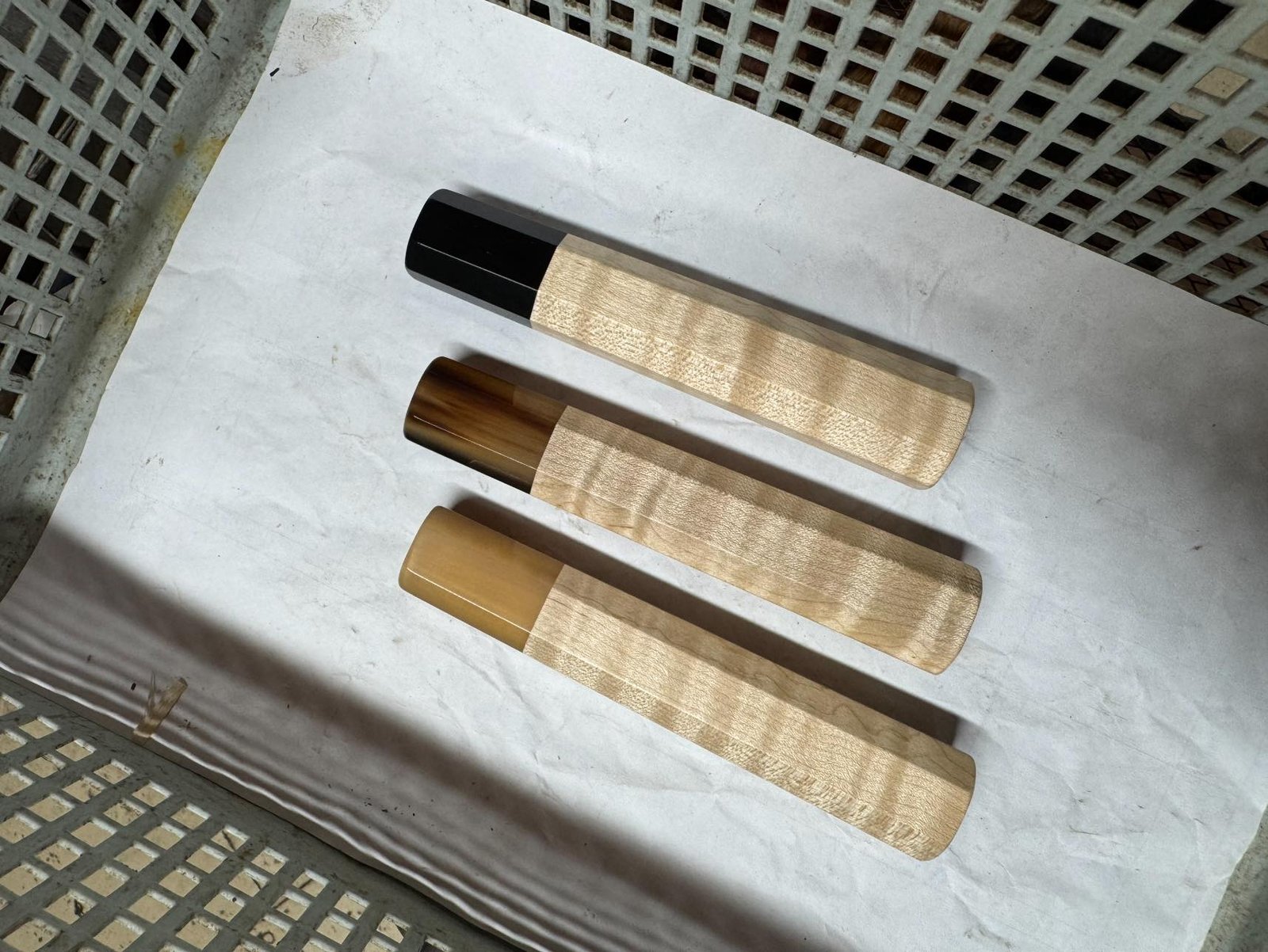 Curly Maple handles with blonde, marbled, and black horn ferrules