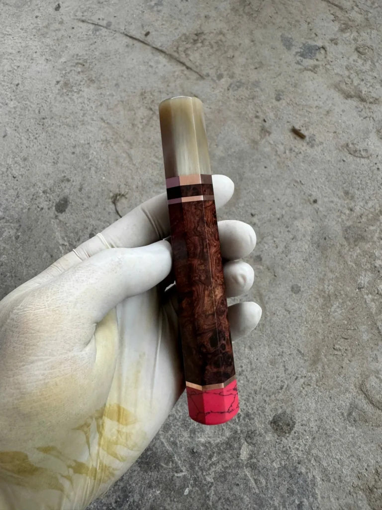 Amboyna burl wa handle showing the pink coral end cap and copper spacer at the butt