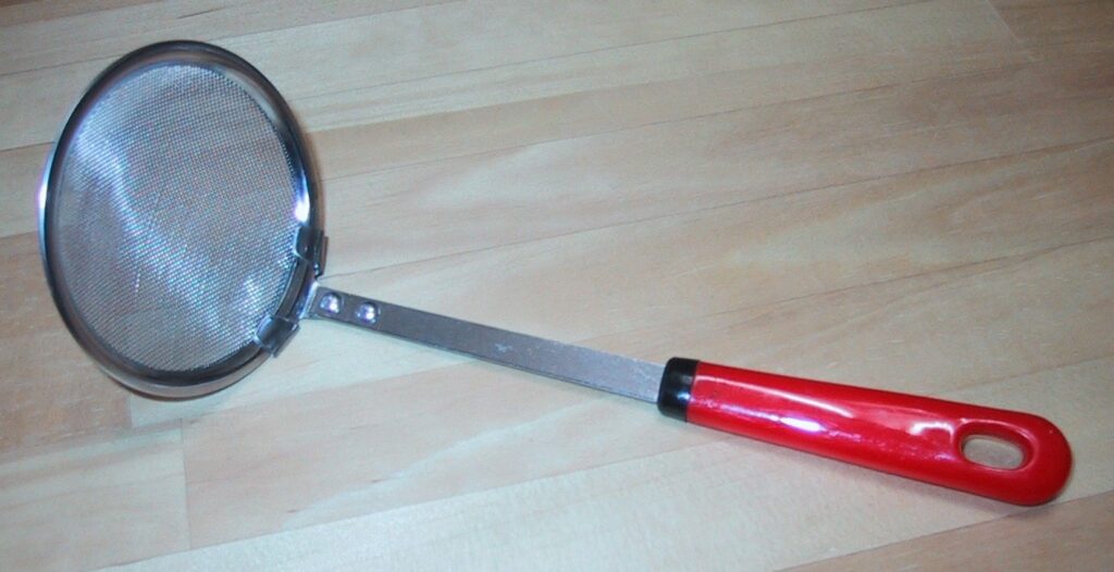 Shallow round mesh skimmer with a long red handle