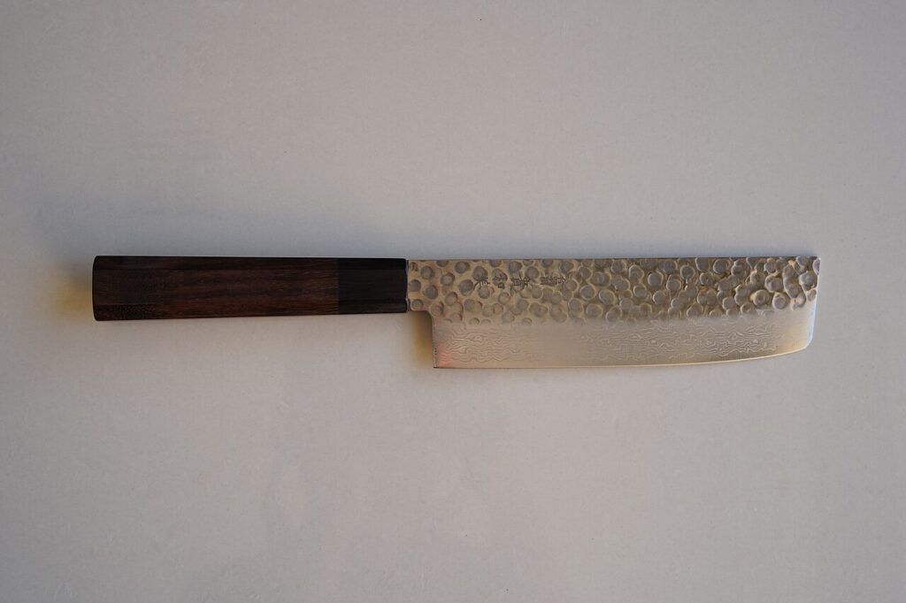 AUS-10 nakiri with a hammered, layered blade viewed from above