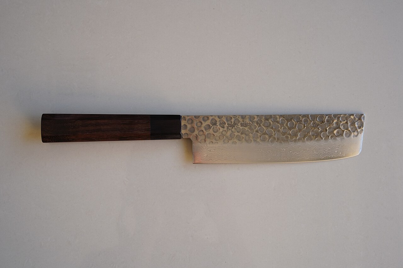 AUS-10 nakiri with a hammered, layered blade viewed from above