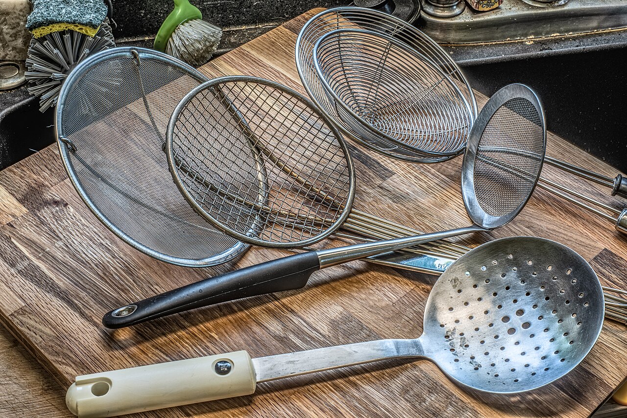Five kitchen skimmers with fine mesh, wider wire openings and a perforated spoon