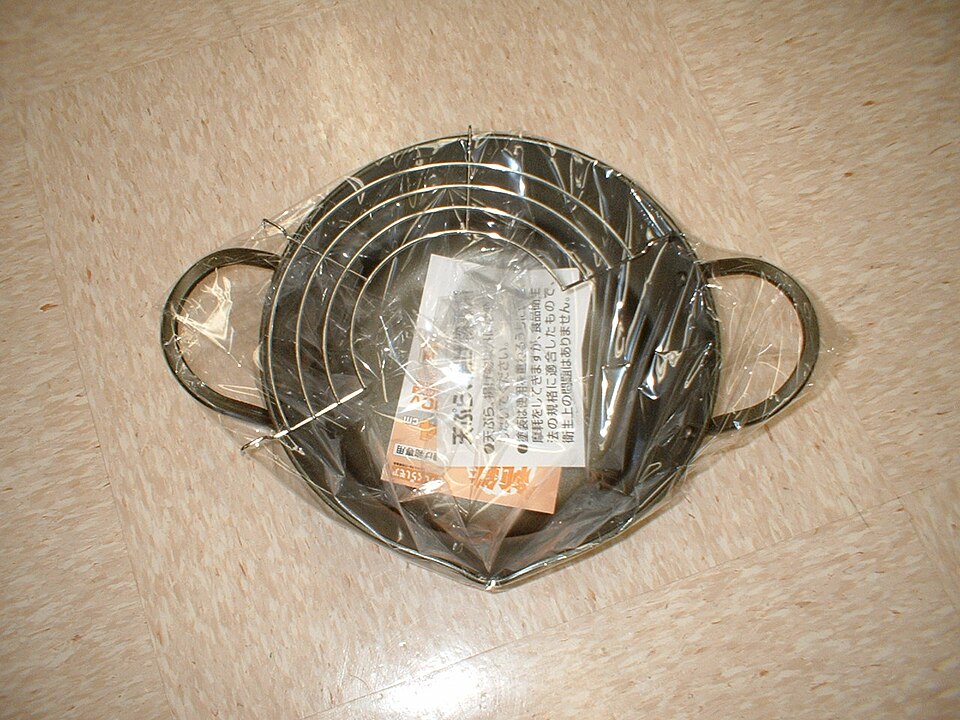 Small tempura pot with two handles and a draining rack, photographed with packaging inside