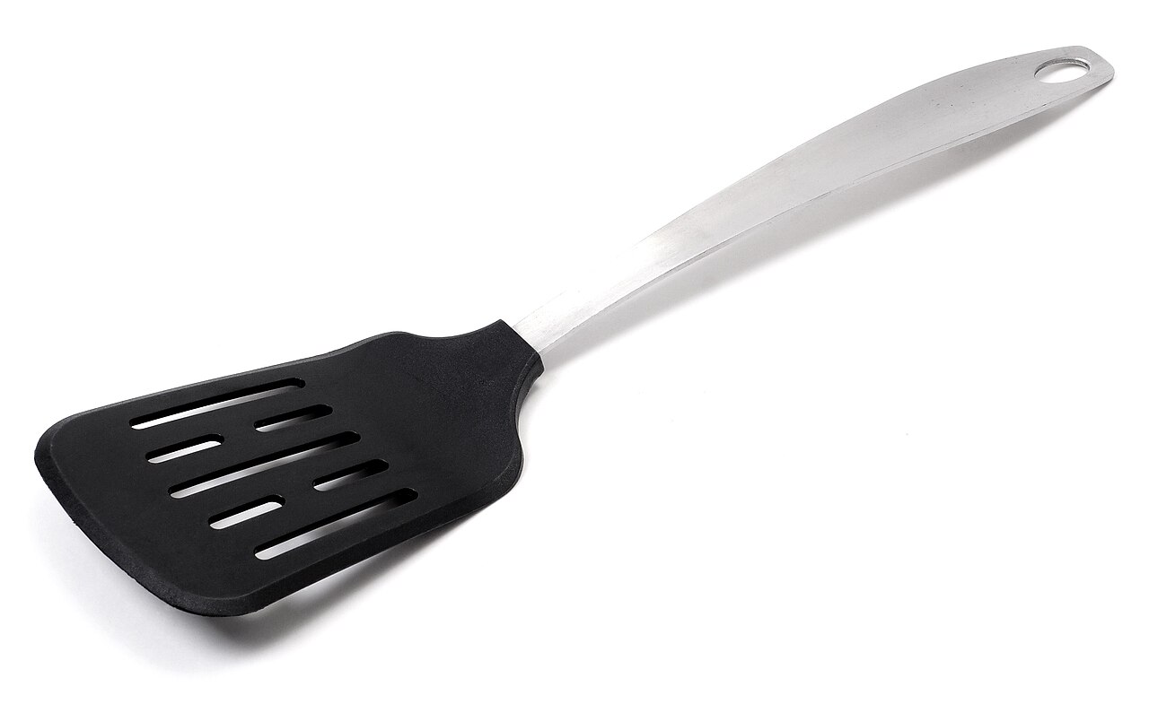 A wide, slotted non-metal turner with a stainless-steel handle.