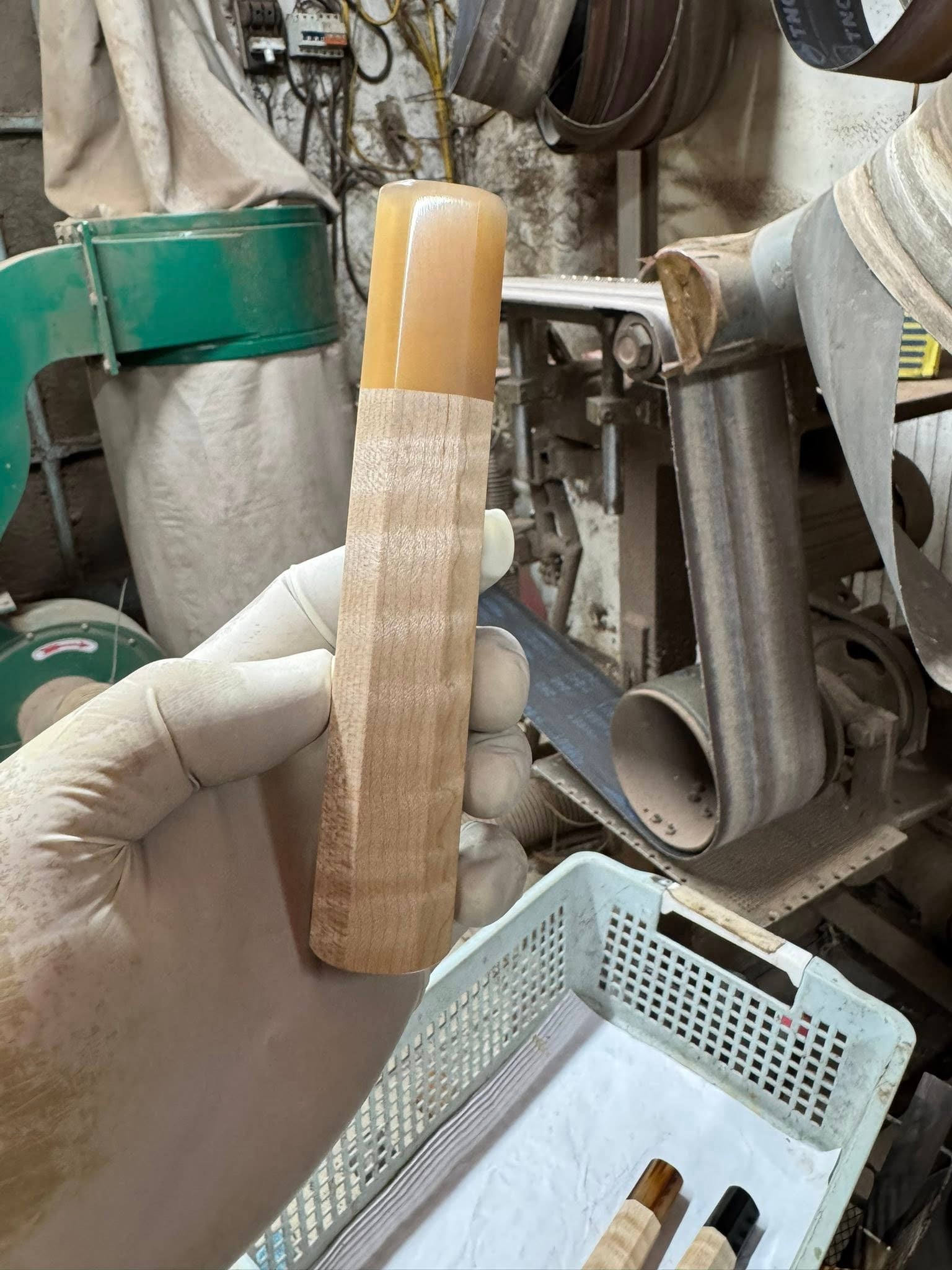 Closeup of a horn ferrule meeting a figured wood wa handle at a clean joint
