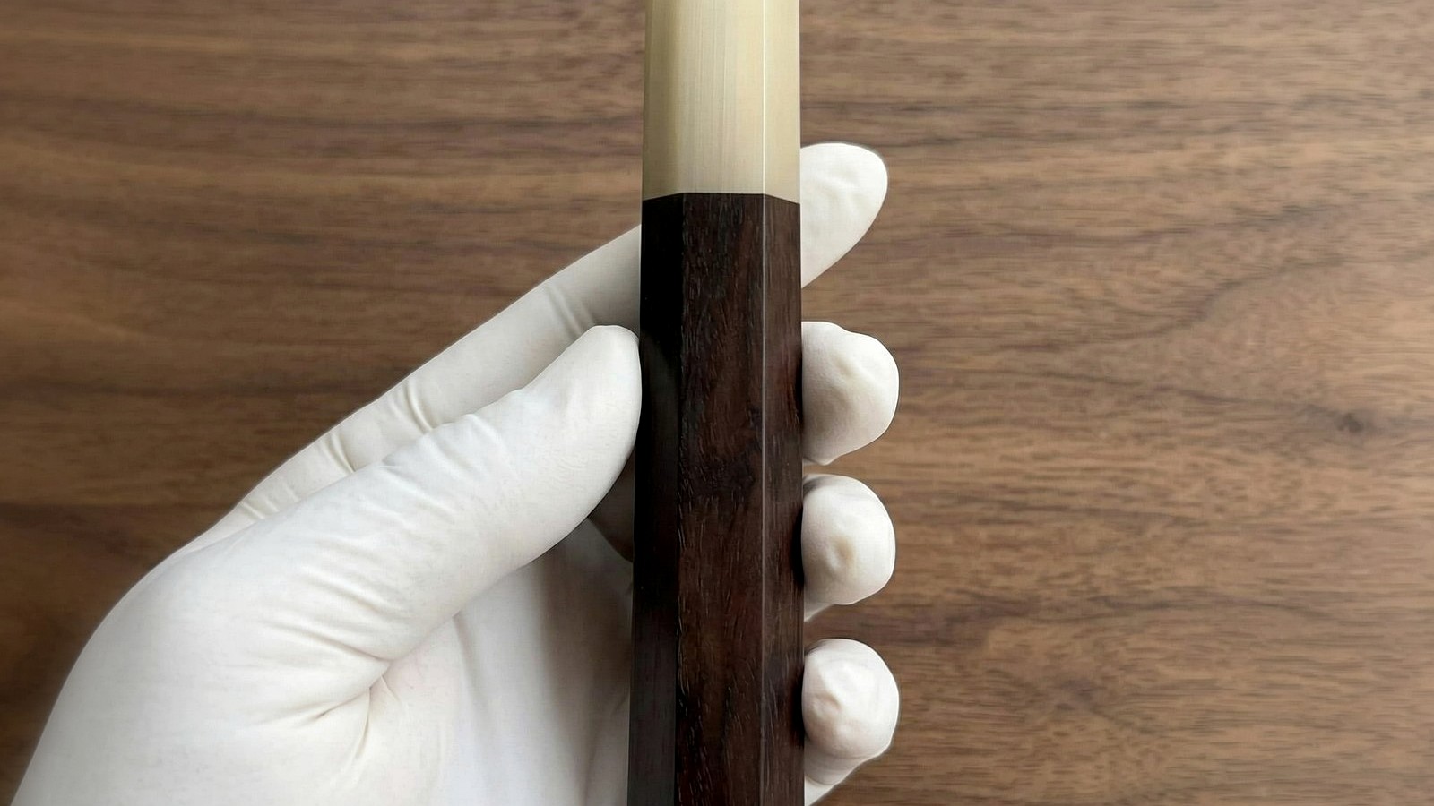 Dark ebony, blackwood, and wenge wa handle blanks on a walnut bench