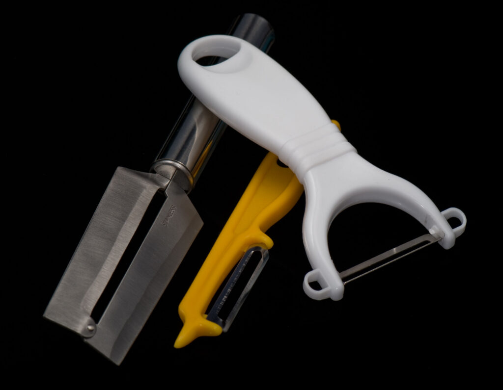 Three handheld vegetable peeler shapes arranged side by side